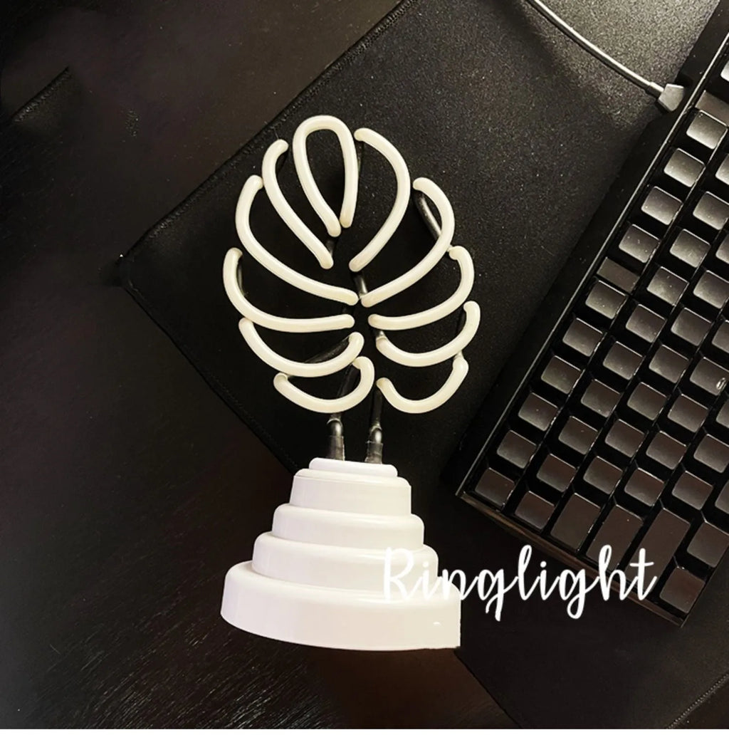 White bamboo-shaped desk lamp with green light, showing USB cable and two size options.