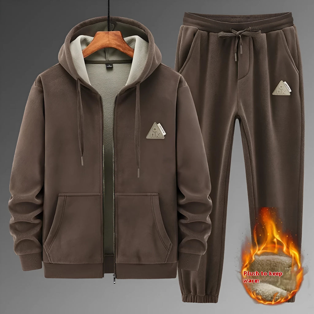 Man wearing a grey hooded sweater and matching trousers from a casual sports suit set.