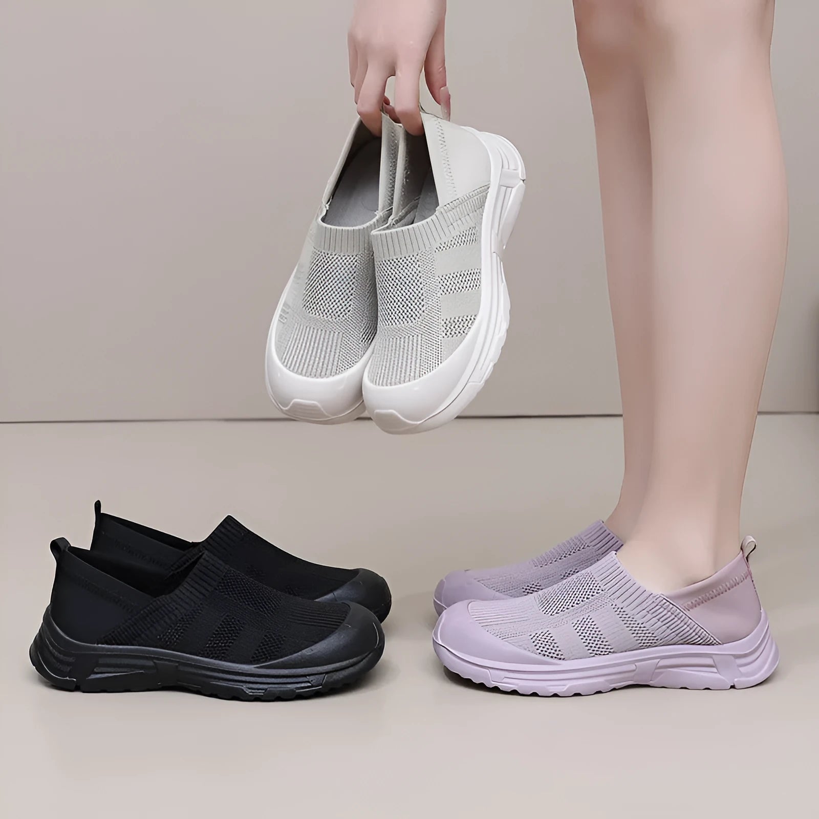 Women's black slip-on shoe cover with breathable cloth upper and flat PVC sole.