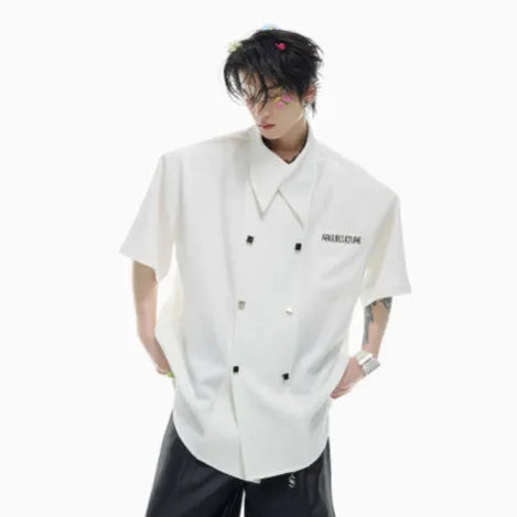 A man's loose-fitting short-sleeved casual shirt in a choice of black, blue, or white, showing lapel collar and metal decoration details.