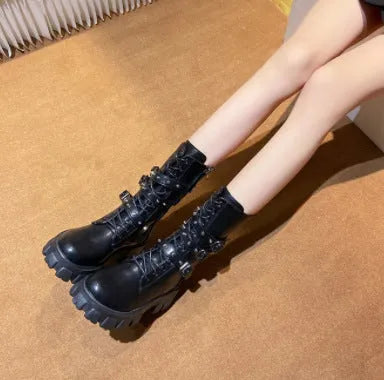 Black women's mid-calf boots with metal buckles and a side zipper on a white background.