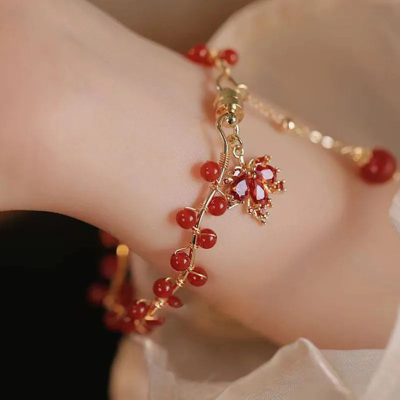 Red ginkgo leaf charm on an alloy magnetic bracelet in a Chinese style.