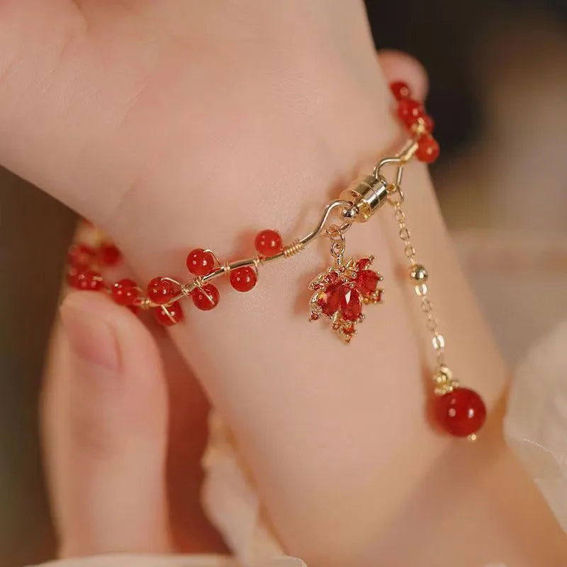 Red ginkgo leaf charm on an alloy magnetic bracelet in a Chinese style.