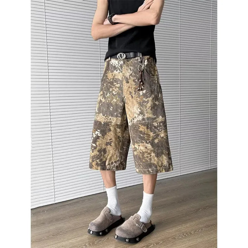 Yellow jeans with a snake camouflage pattern, shown in a cropped length.