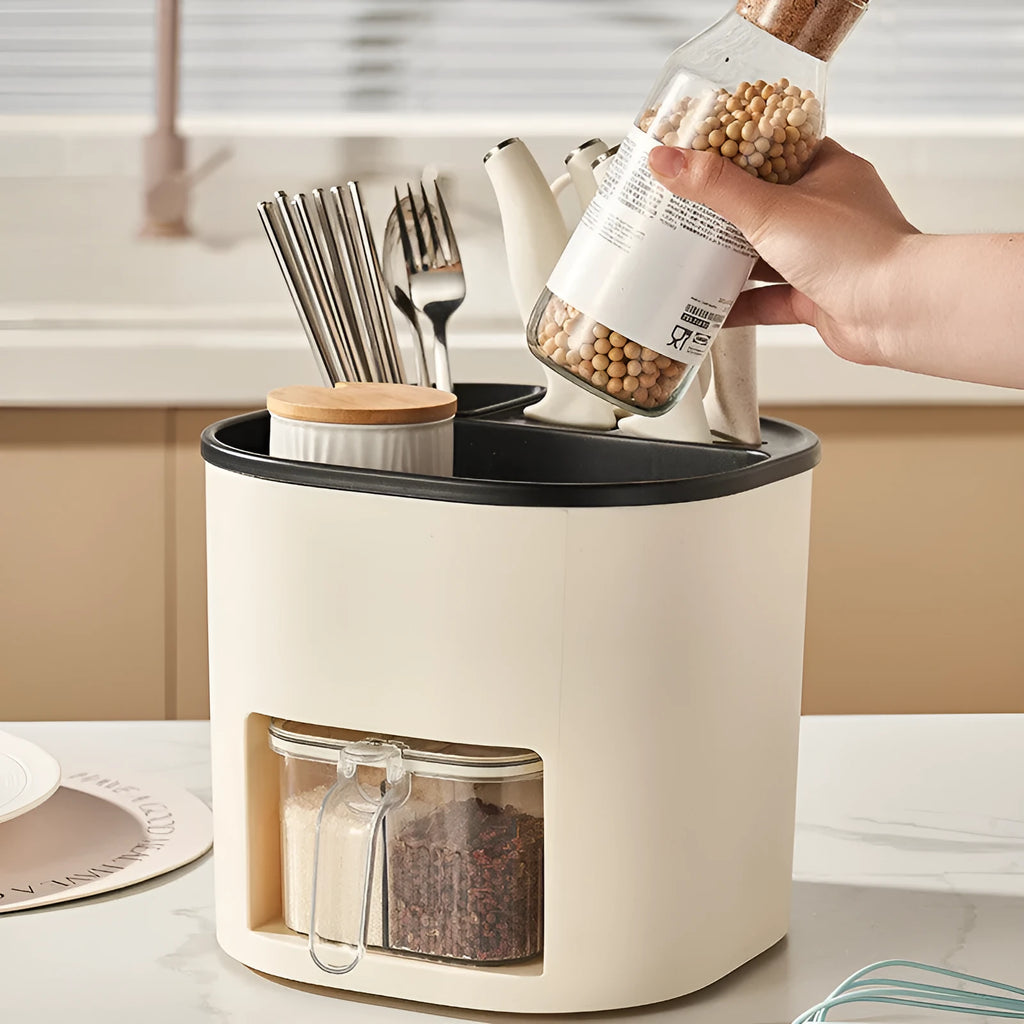 White rotating kitchen storage bucket with four-compartment spice box lid next to cutlery.