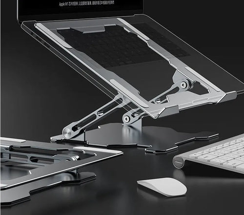Grey aluminium adjustable and foldable laptop stand on a wooden desk.