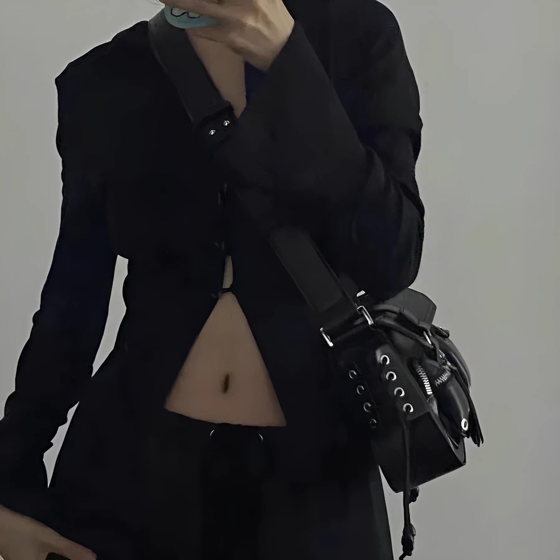 Black PU messenger bag with adjustable crossbody strap showing internal zipper change compartment