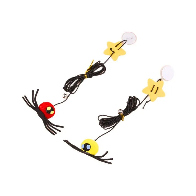 Red hanging cat toy with elastic rope, feathers, and bell spider ornament mounted on door