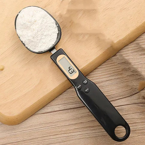 White digital kitchen spoon scale with LCD display showing weight measurement