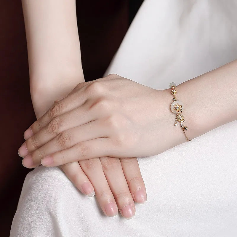 Women's antique bracelet with Hetian jade inlay and lotus peace buckle design in 925 silver