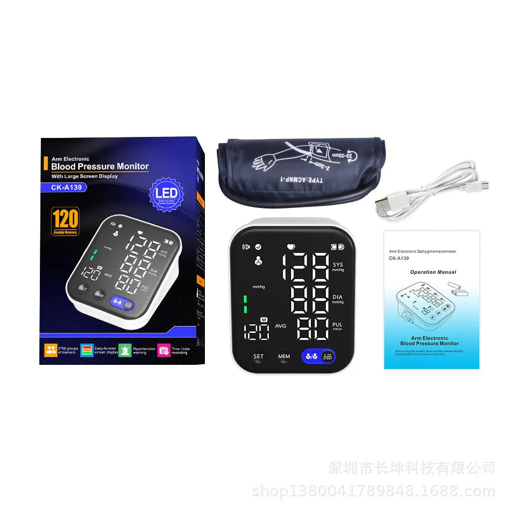 White electronic blood pressure monitor with large LCD screen and attached upper arm cuff