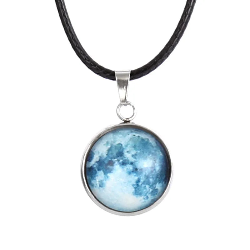 Close-up of a luminous alloy necklace with a glass pendant featuring a Christmas moon night sky and constellation design.