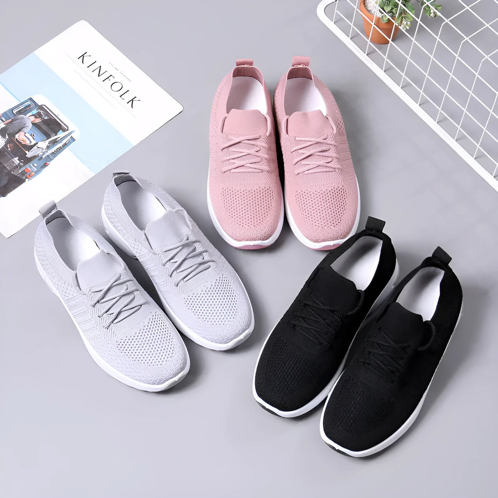 Women's black mesh lace-up sneakers with round toe and non-slip PVC sole on a white background.