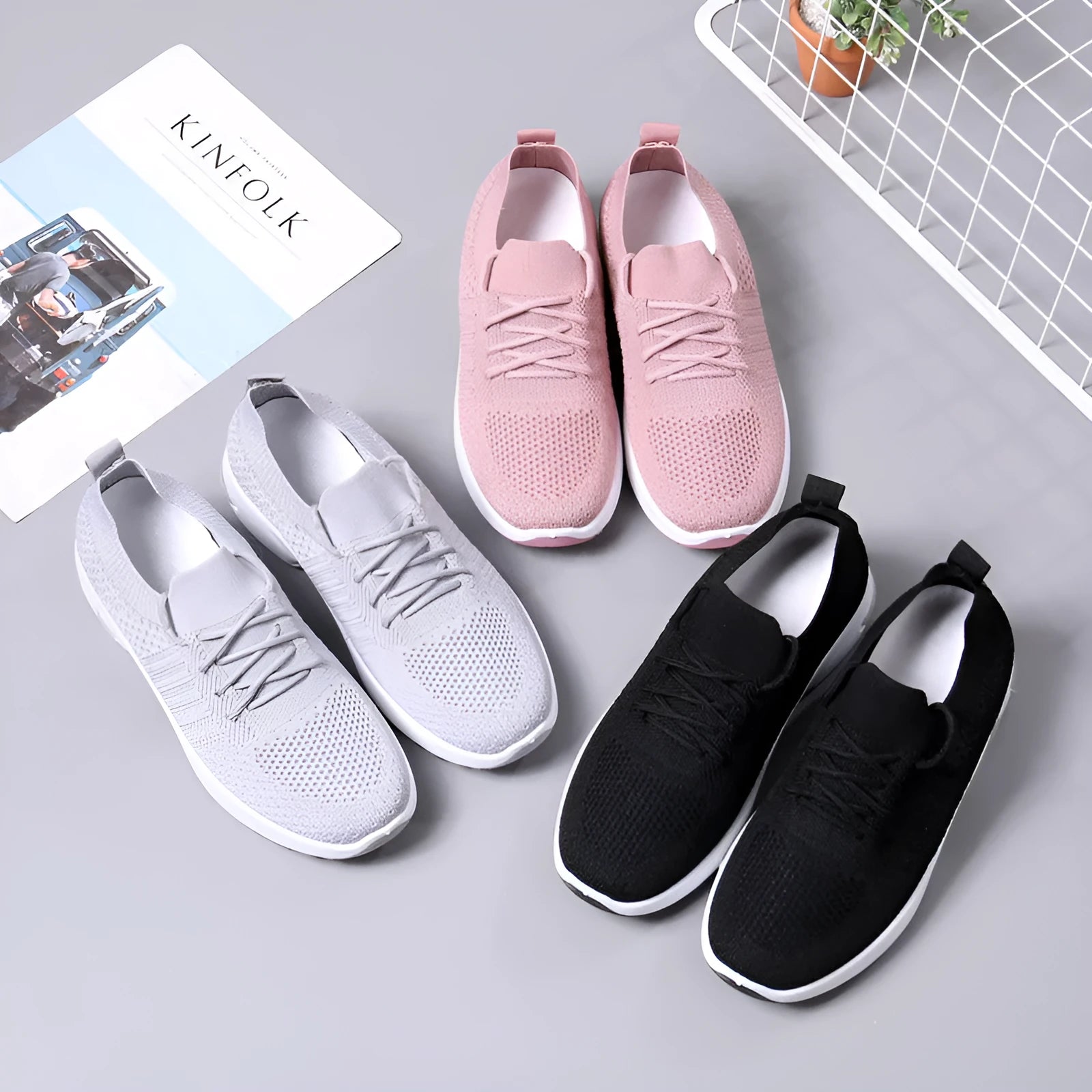 Women's black mesh lace-up sneakers with round toe and non-slip PVC sole on a white background.