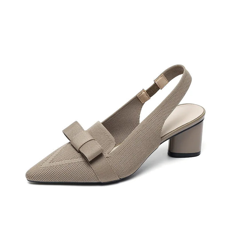 Women's black closed toe high heel sandals with a bow detail and an ankle strap on a rubber sole.