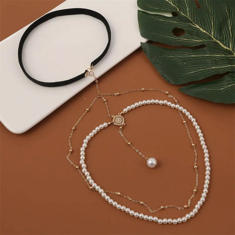 Women's white pearl multi-layer geometric body chain anklet on a light background