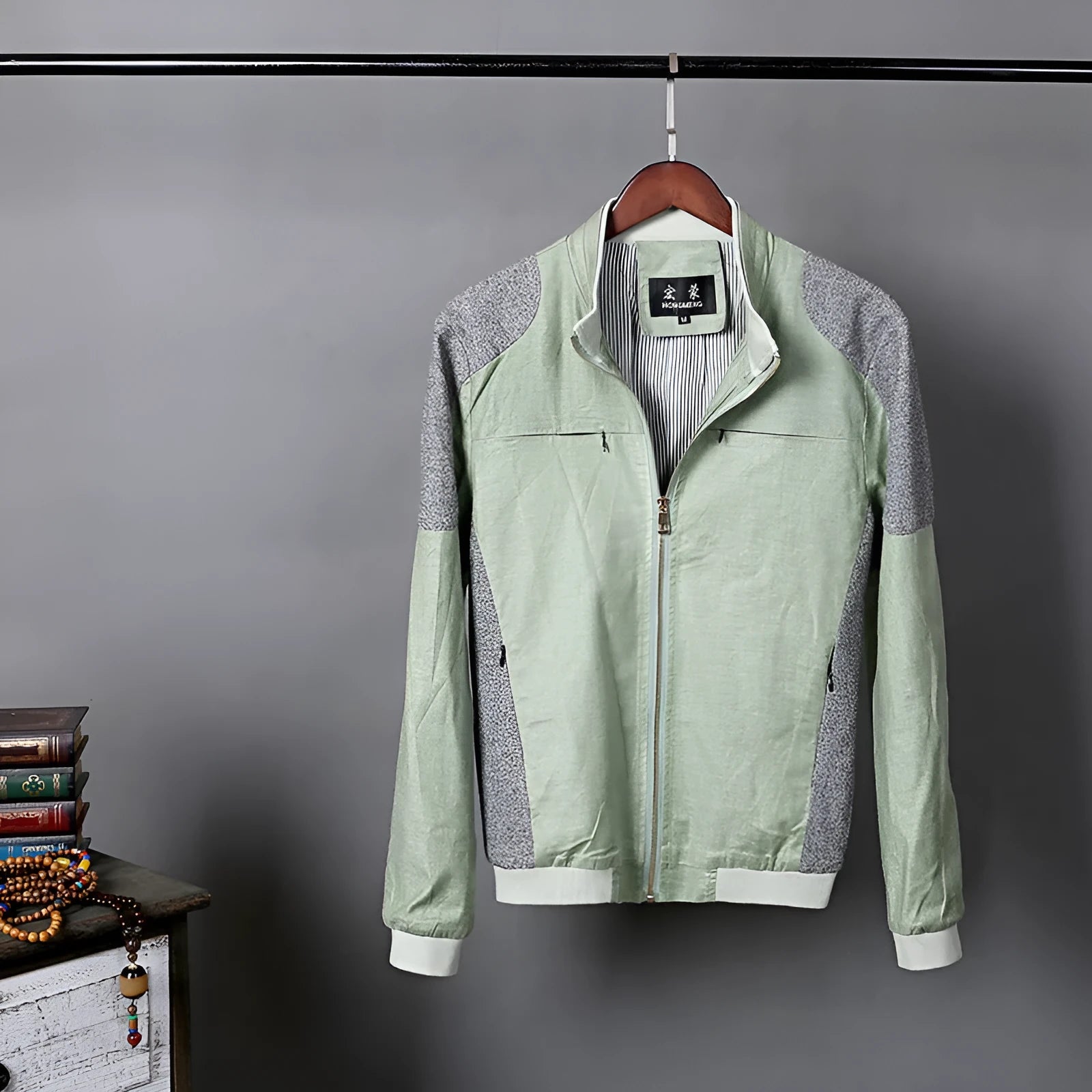 Men's thin blue linen casual jacket with a regular fit on a hanger.