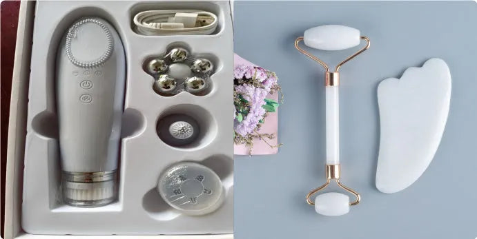 White jade facial roller and gua sha scraping board set on a table.