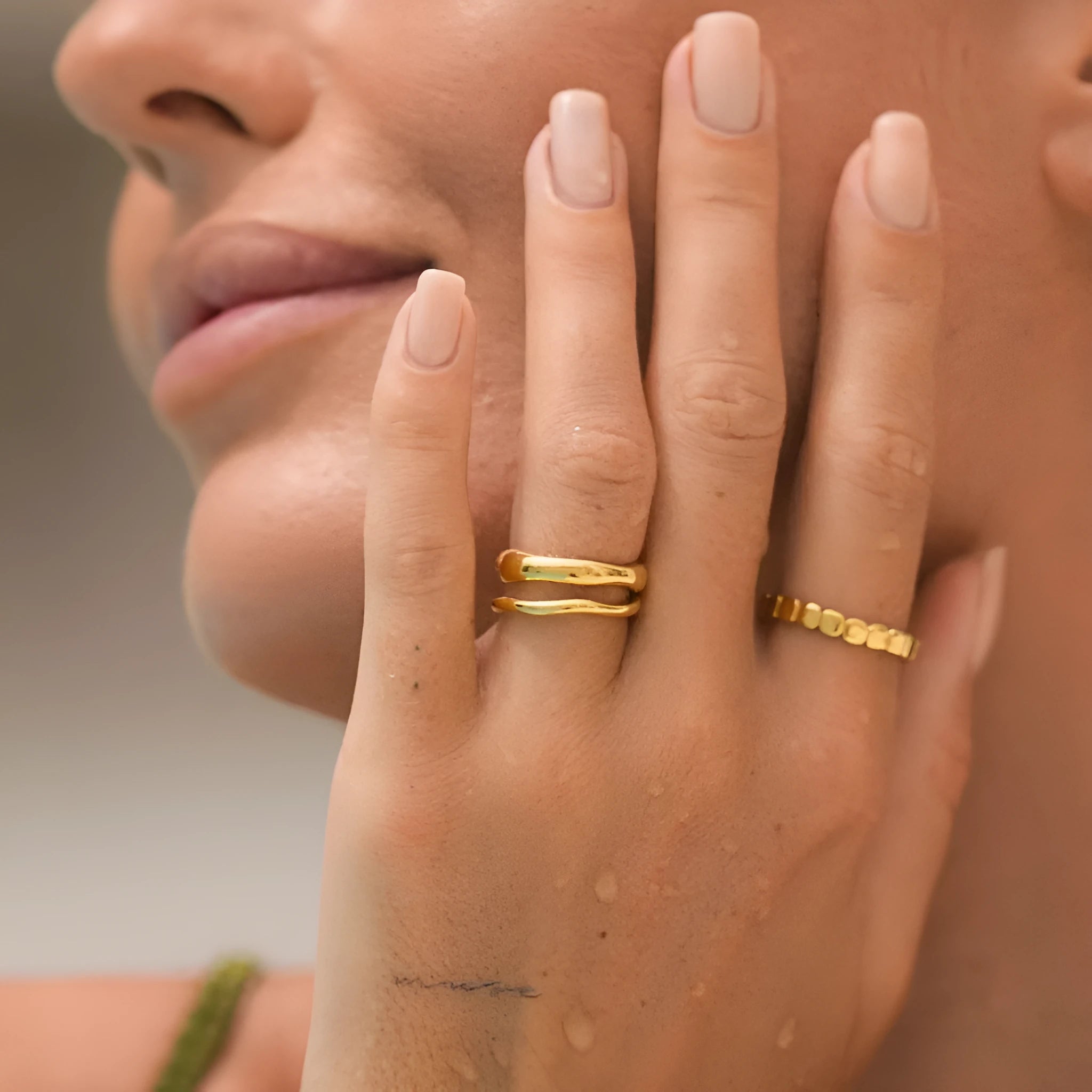 Irregular wave stainless steel ring in colour NXR28 on a plain background, unisex size No 6
