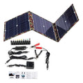 Black foldable 36W solar panel unfolded showing three monocrystalline silicon cells with charging accessories