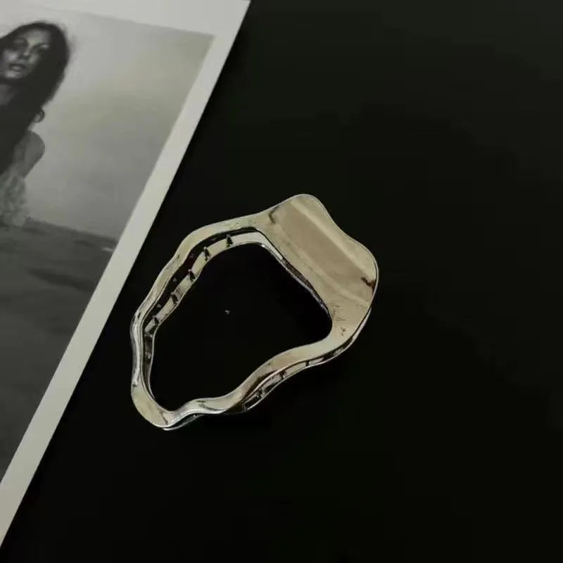 Gold and silver zinc alloy hair barrettes showing arc, square, and triangle shapes on a plain background.