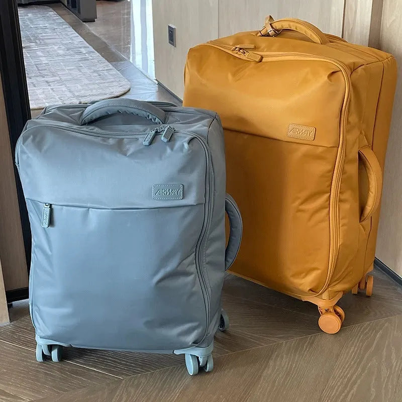Ultra-light waterproof Oxford cloth suitcase in bluestone green with universal wheels, shown with a 24-inch size example.