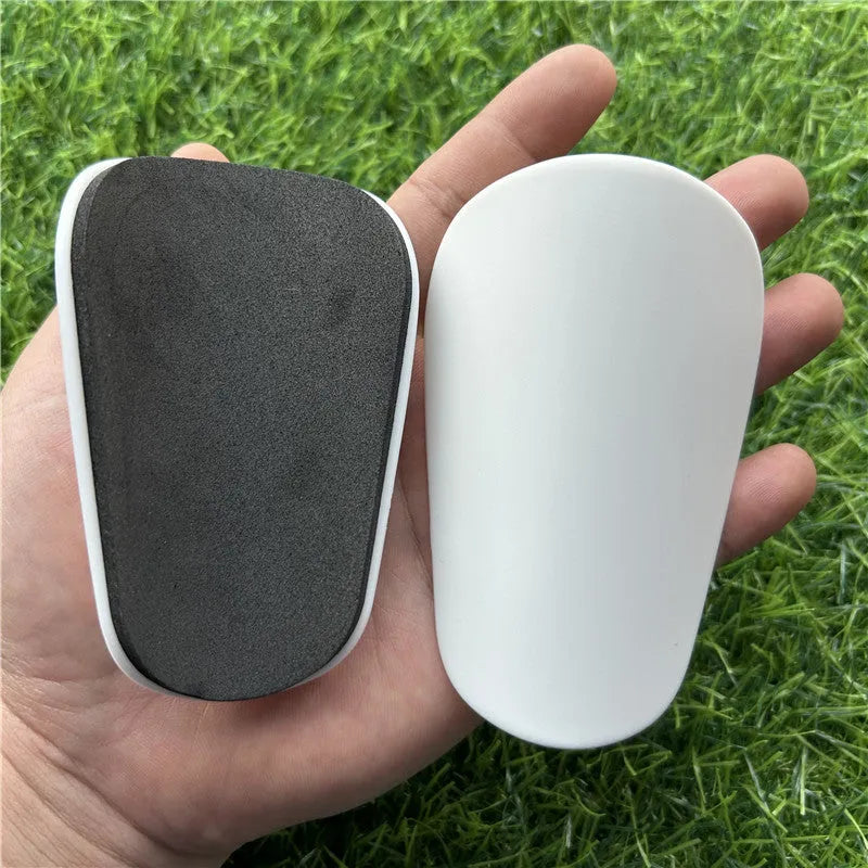 Extra small mini football shin guards in black and white plastic for youth players