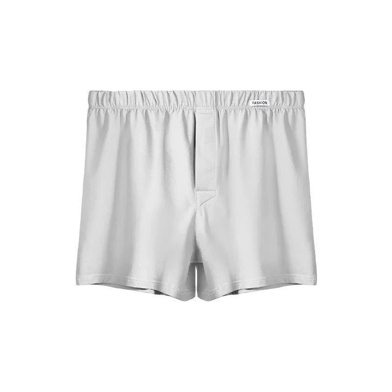 Men's loose-fitting cotton boxer shorts in gold, green, sea blue, and light grey colours showing mid-waist design
