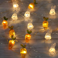 Easter LED bunny string lights with carrot and white rabbit bulbs on a dark background