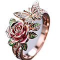 Close-up of an adjustable alloy ring with a colourful oil-drip finish, showing detailed butterfly and floral modelling.