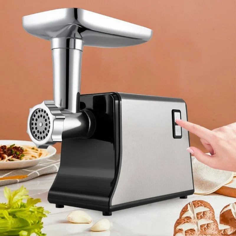 Silver meat grinder with double mixing blade, aluminium tray, and attachments on countertop