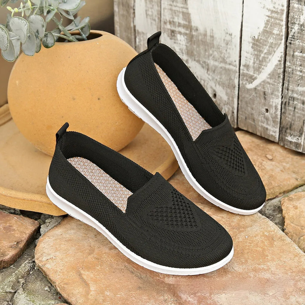 Women's plus size beige slip-on loafers with heart pattern and mesh lining.