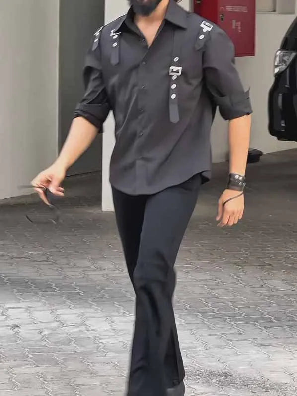 Man wearing a black utility-style button-up polyester shirt with a regular fit.