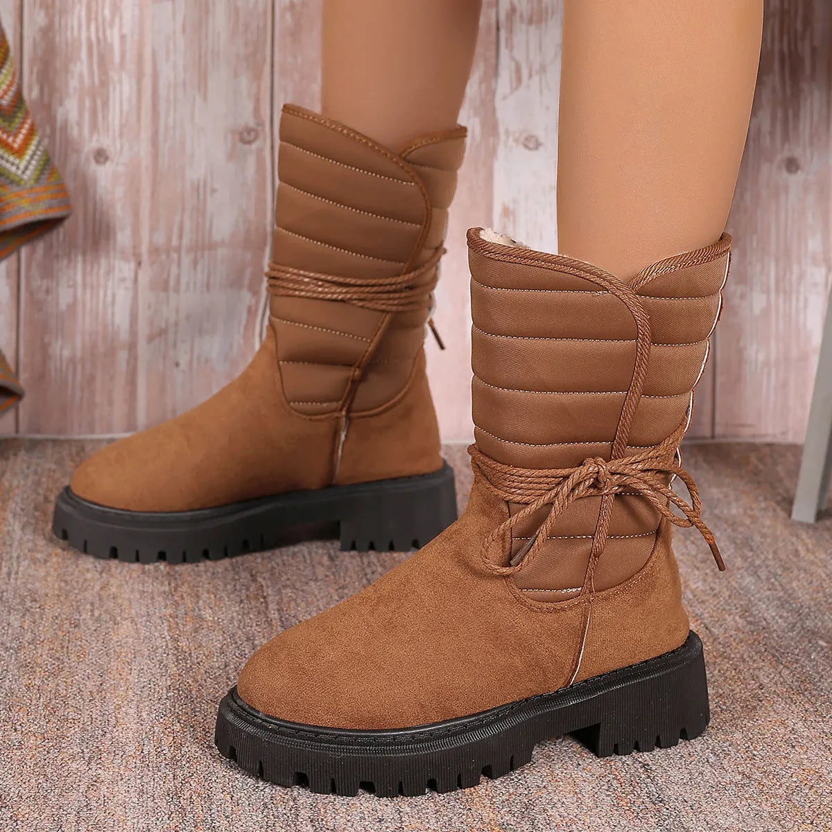 Women's black suede snow boots with chunky heel, lace-up design, and fleece lining on a white background.
