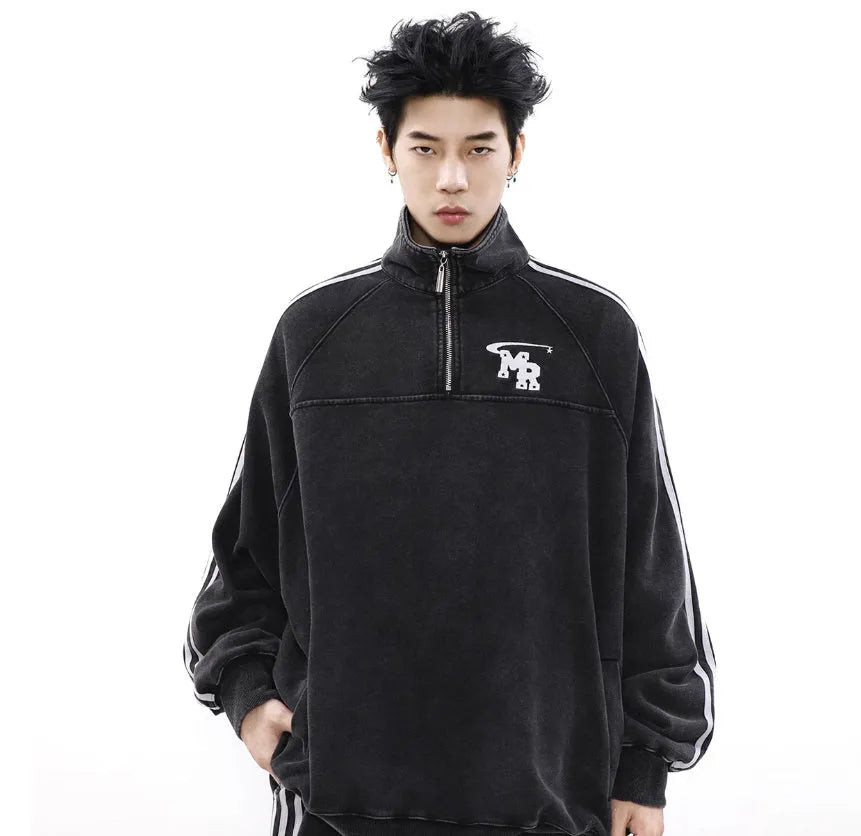 Man wearing a black American retro stand collar long sleeve hoodie coat.