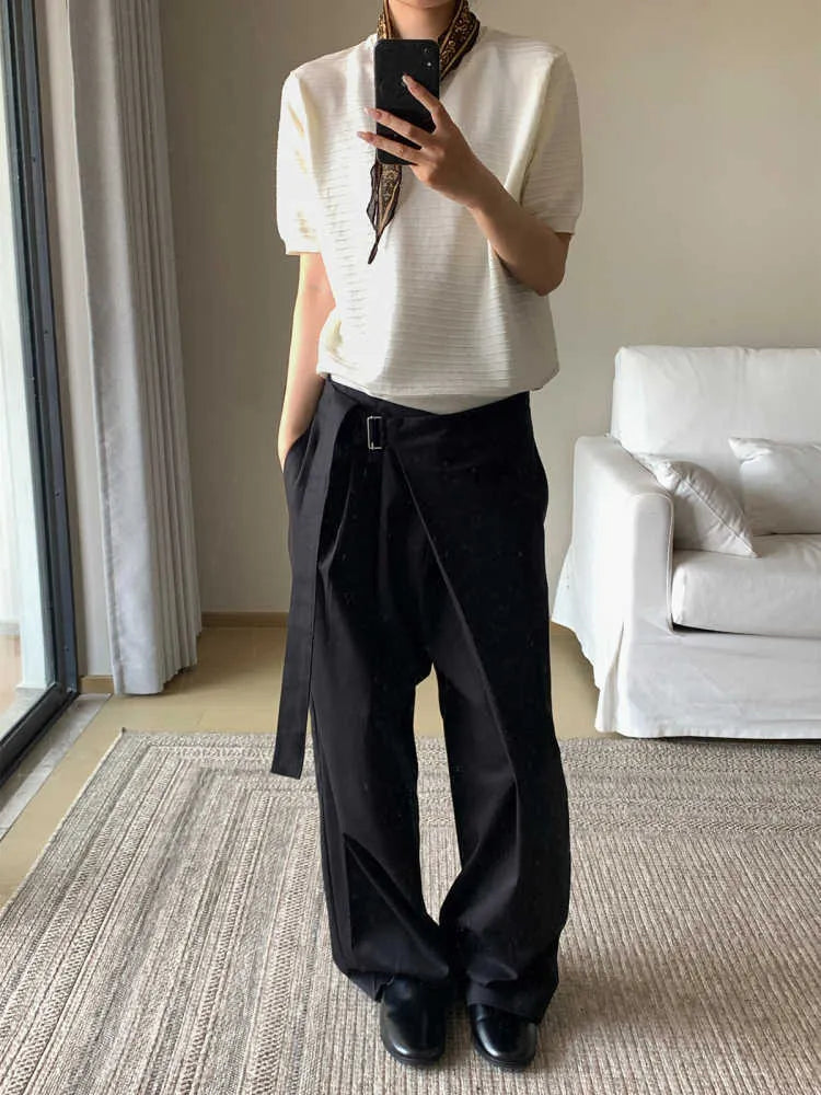 Black straight-leg trousers with adjustable waist and single pleat detail on a hanger.