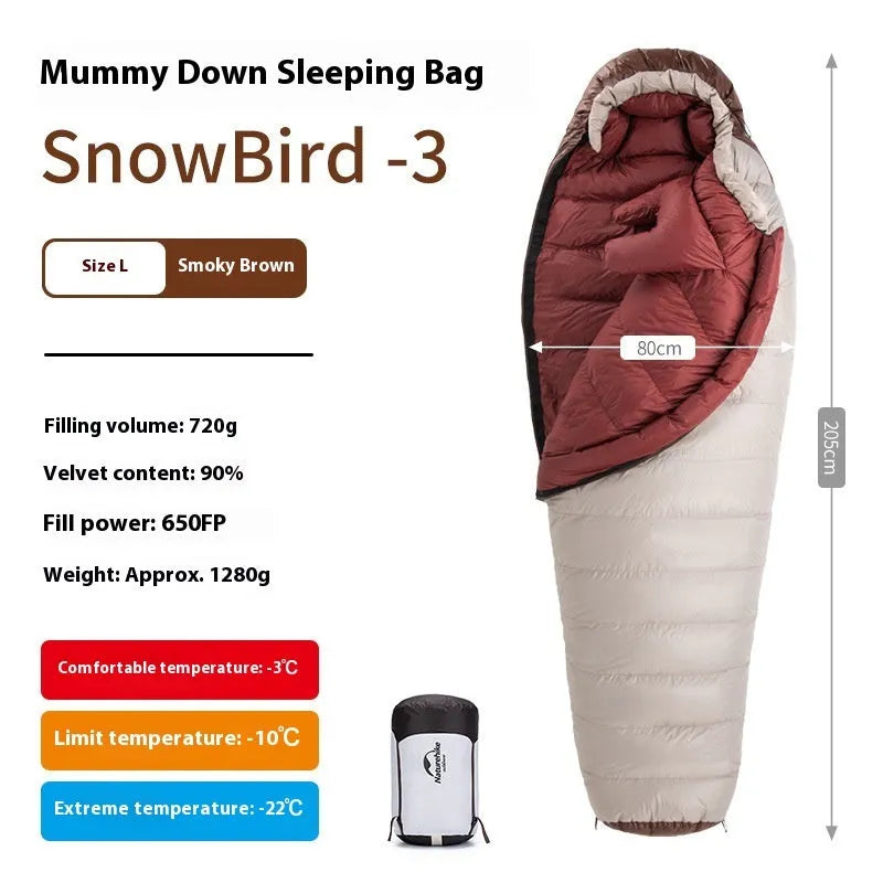 Adult mummy-style sleeping bag with goose down filling shown with its storage bag.
