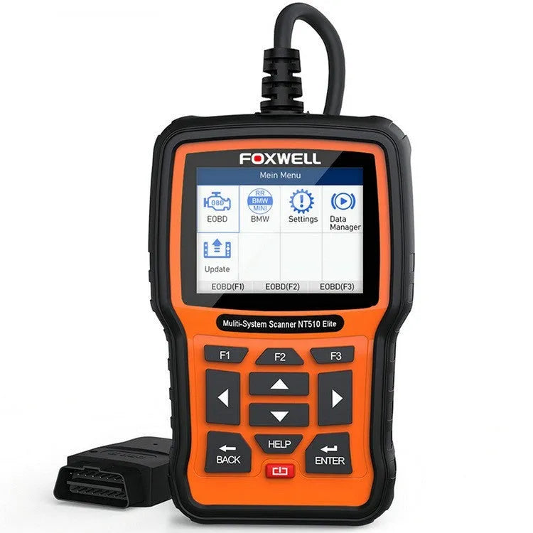 Foxwell NT510 orange and black automotive diagnostic scanner with data cable on a workshop bench