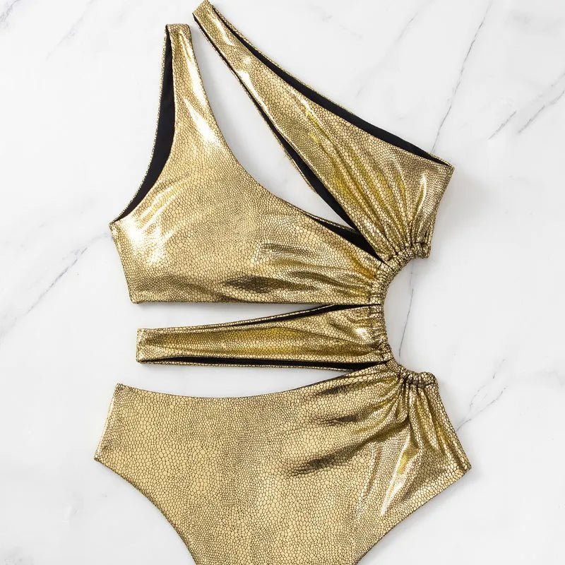 Women's gold backless one-piece swimsuit with spandex material on mannequin