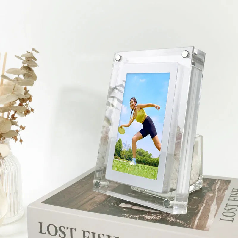 White vertical digital picture frame with 5-inch screen on a table