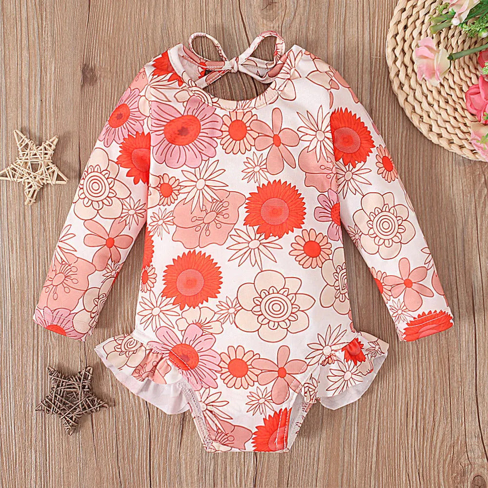Girls floral print swimsuit with crew neck front and open back in orange colour