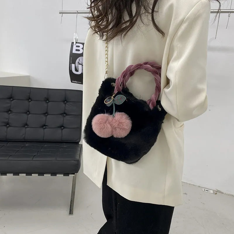 Large capacity soft plush bucket bag in beige with open outer pocket and single shoulder strap