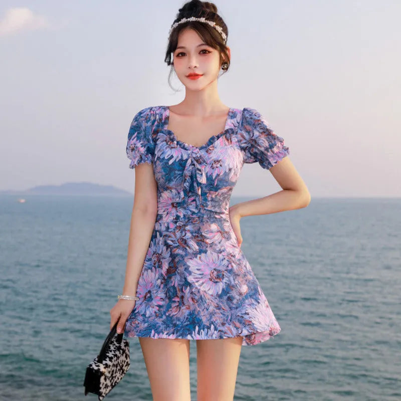 Women's solid blue one-piece swimsuit on a mannequin, front view.