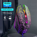 Black and white wireless gaming mouse with RGB lighting on desk with charging cable