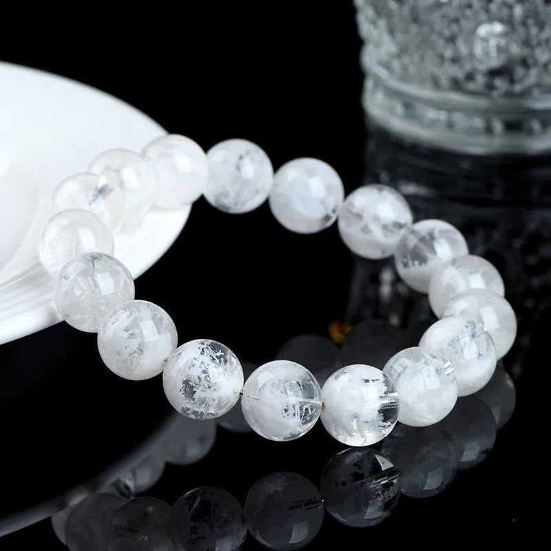 Women's bracelet with round blizzard snowflake crystal beads in geometric shapes on a wrist.