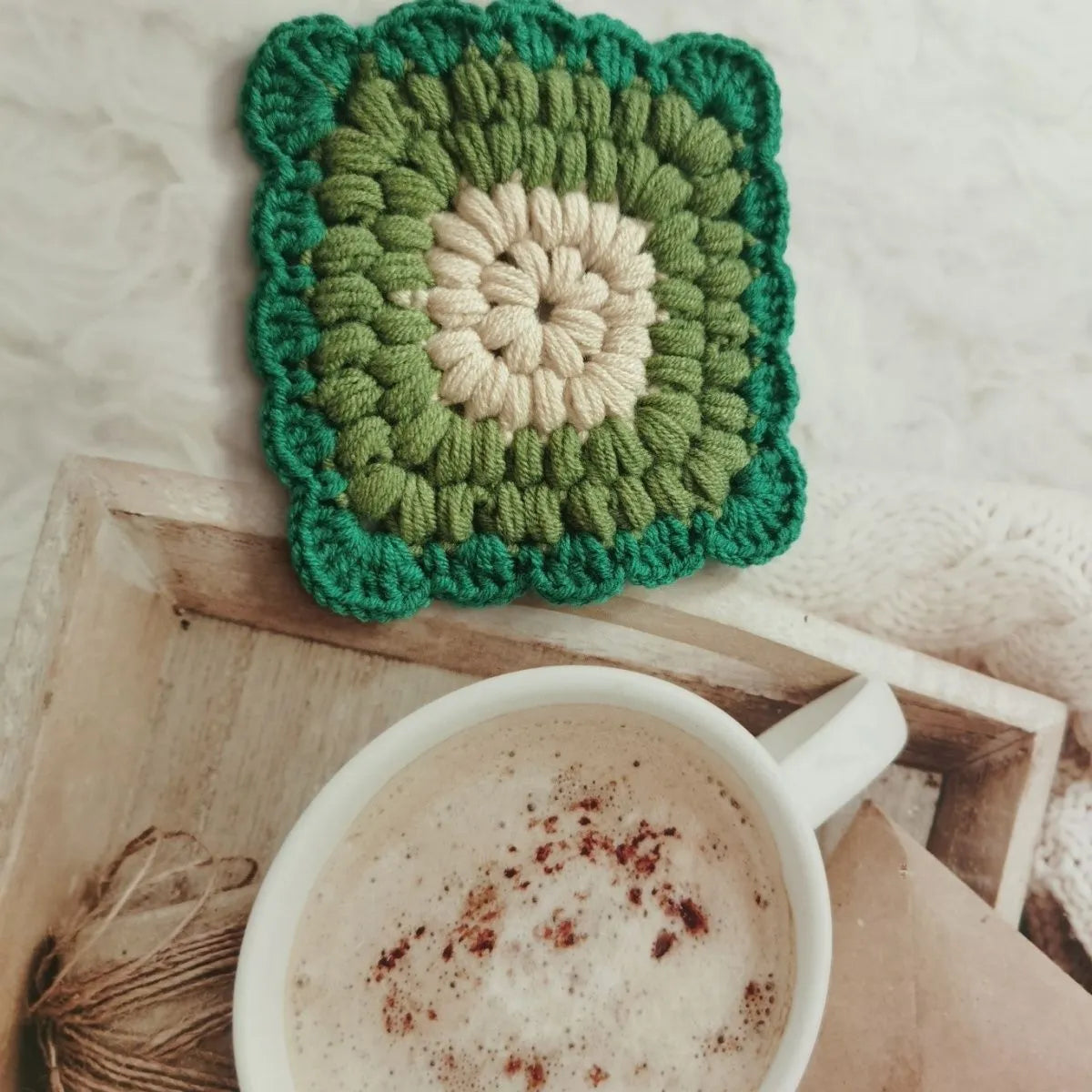 Crocheted wool insulated cup placemat with grandmother lattice pattern in choice of colours