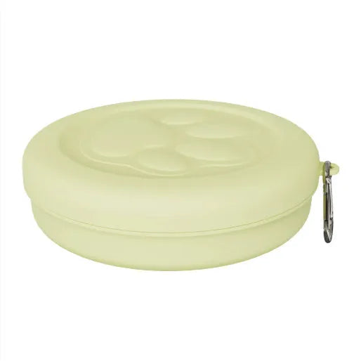 Collapsed and open views of a pink silicone dog bowl with matching sealing lid, next to a dog lead.