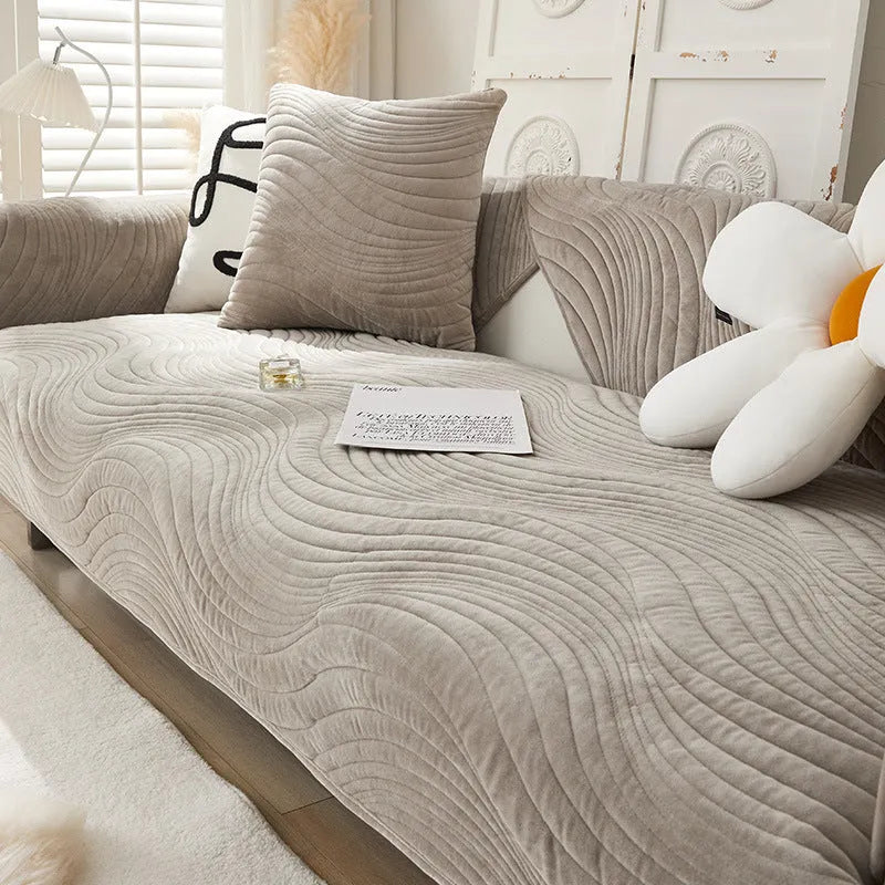 Thickened non-slip flannel sofa cover with geometric pattern in beige on a modern sofa