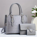 PU leather crossbody bag three-piece set showing bucket bag, wallet, and card holder in contrasting minimalist texture