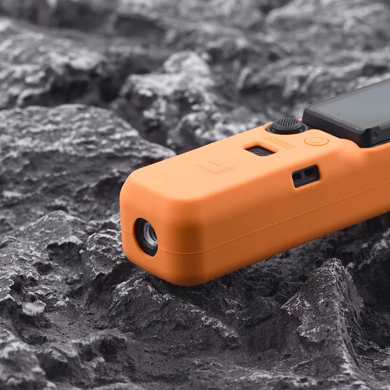 Black silicone protective sleeve for a PTZ camera, shown next to red and orange versions.